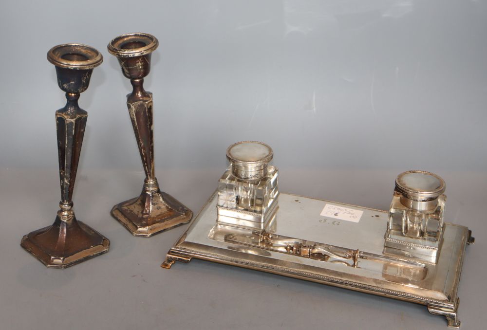 A silver desk stand and a pair of silver candlesticks